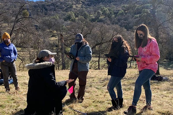 High school students learning how to monitor rangeland in the field