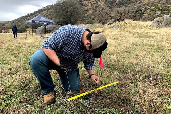 HomerRanchPreserve_EleanorRoosevelt7_SamWeiser Man using yardstick, a smart device and a pinflag for on-site analysis.