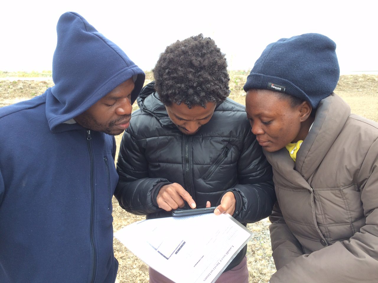 three people using the app in the field