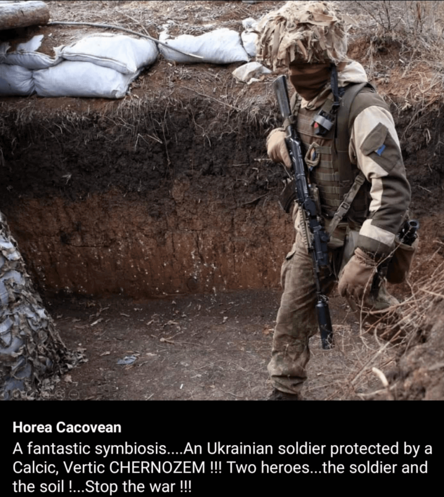 A social media post by Horea Cacovean showing a Ukrainian soldier in a pit dug into the earth. The caption reads, "A fantastic symbiosis... An Ukrainian soldier protected by a Calcic, Vertic CHERNOZEM !!! Two heroes...the soldier and the soil !...Stop the war !!!